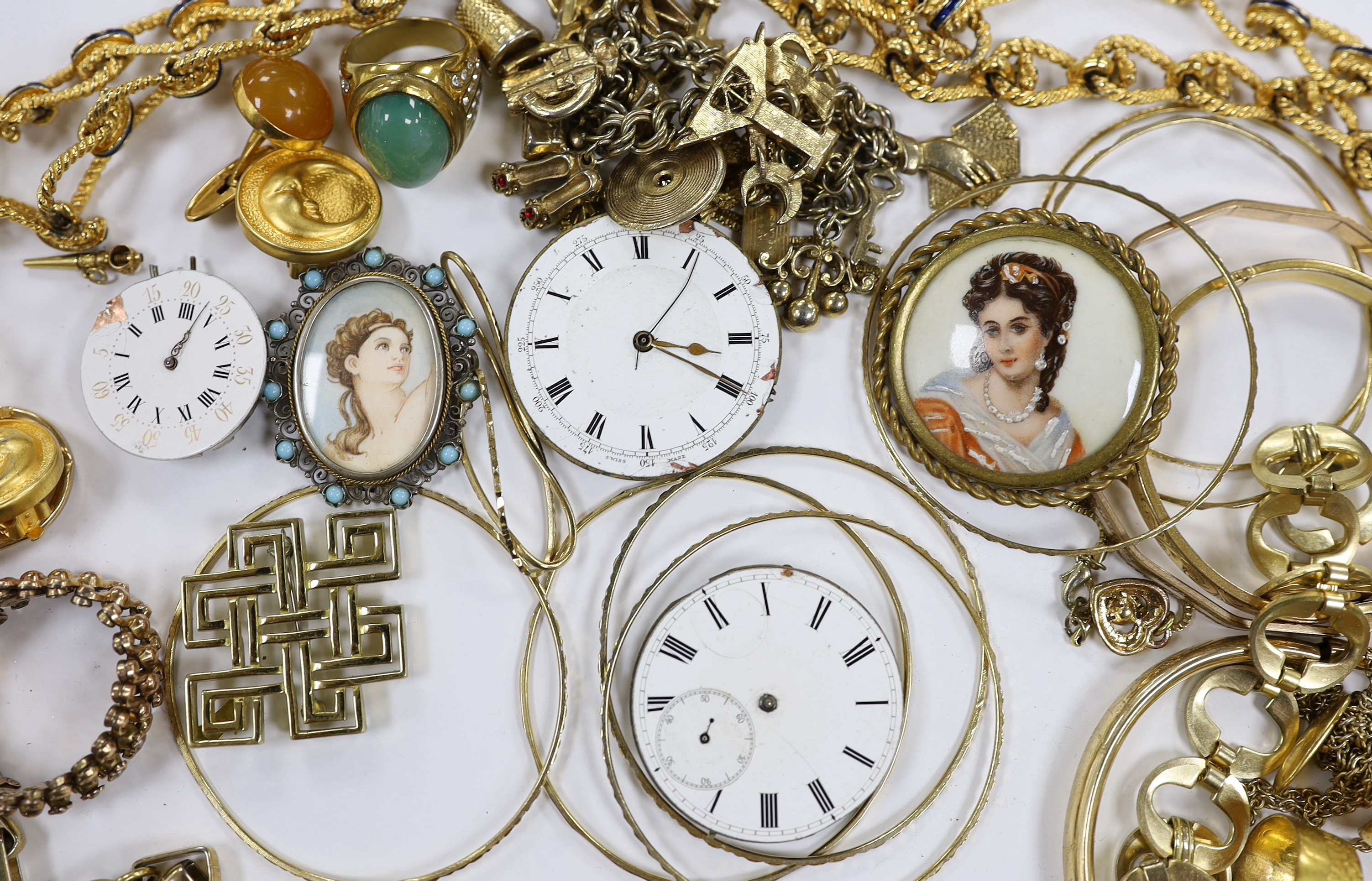 A small quantity of assorted gilt metal or gold plated jewellery, including large cub link necklace, bangles, bracelets, rings, cufflinks etc and three pocket watch movements.